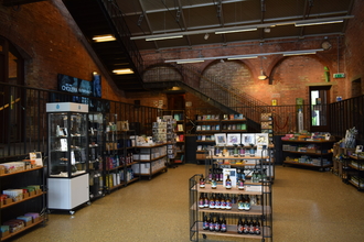 The gift shop at walthamstow wetlands with stands and displays full of products