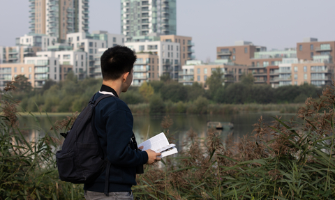 Young person with book at Woodberry Wetlands