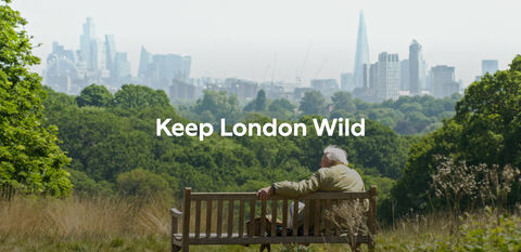Sir David Attenborough sitting on a bench looking over the London cityscape. Text reads: Keep London Wild