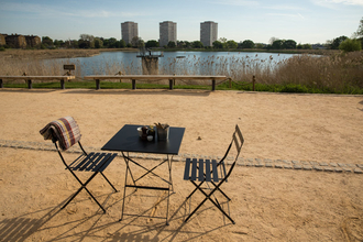 Outdoor seating at the Coal House Cafe, Woodberry Wetlands. Two chairs and a table.
