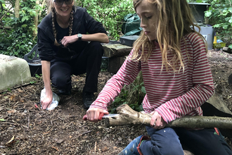 child using knife in forest school