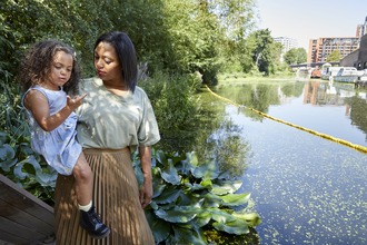 Woman and child on canal at Camley Street Natural Park