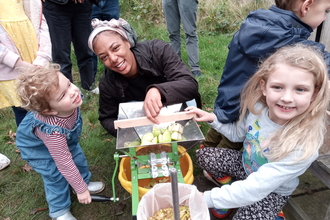 People apple pressing at Apple Day at Dulwich Orchard