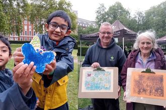 Children and adults with butterfly artwork at Grosvenor Square