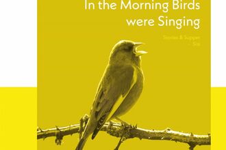 A greenfinch singing, perched on a branch