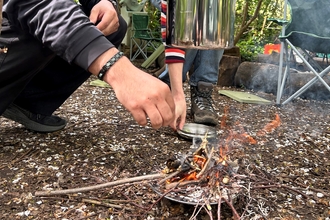 Pot hanging on top of fire 