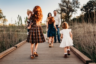 Family in autumn, walking on a boardwalk