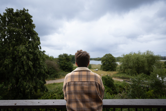 Person looking out at Walthamstow Wetlands from the terrace