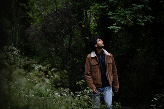 A person walking through a woodland habitat