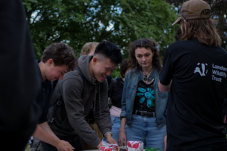 A group of young people planting seeds