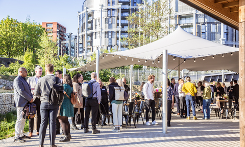 A group of people stand underneath a gazebo at Camley Street Natural Park