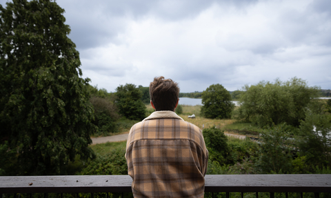 Person looking out at Walthamstow Wetlands from the terrace