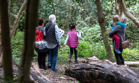 People in the woods exploring