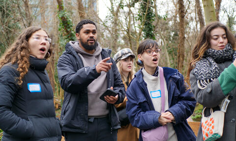  a group of young people looking and pointing