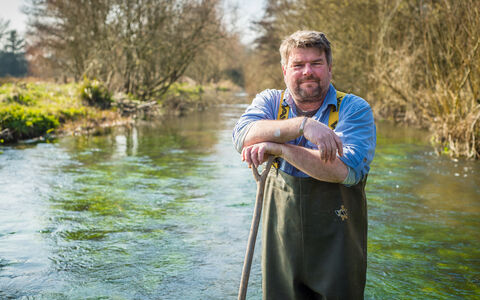 John standing in a river in his waders