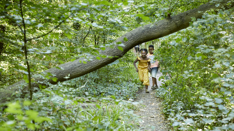 Children running under tree branch at Sydenham Hill Wood