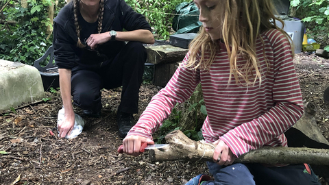 child using knife in forest school