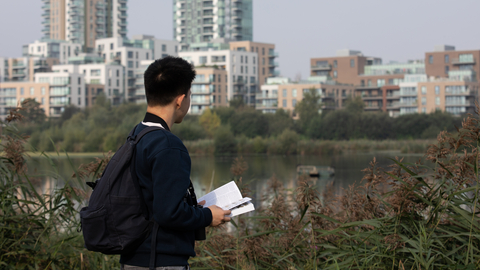 Young person with book at Woodberry Wetlands