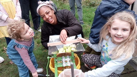 People apple pressing at Apple Day at Dulwich Orchard