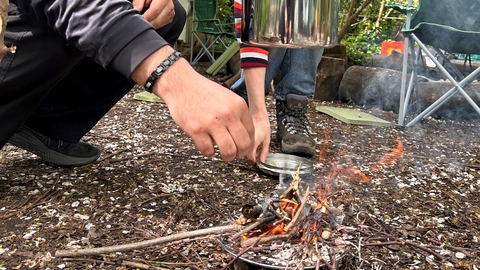 Pot hanging on top of fire 