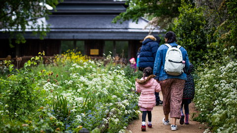 School children and adults walking along the path at Camley Street Natural Park