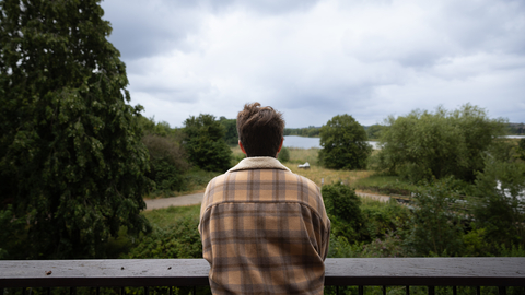 Person looking out at Walthamstow Wetlands from the terrace