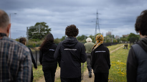 Staff walking away from camera at Walthamstow Wetlands