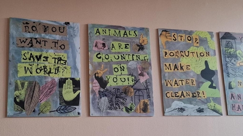 Five hand made zines with pro-nature messages are laid out on a desk