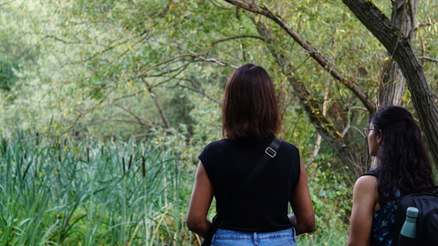 Two women looking out at greenery at Park Road Pond