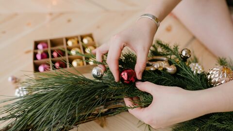 Close-up shot of a person holding a festive wreath