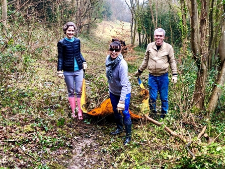 Brilliant butterflies volunteers carrying a bag of scrub clearance
