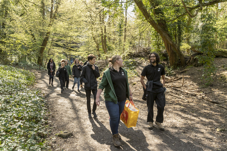 Young people walking through woodland