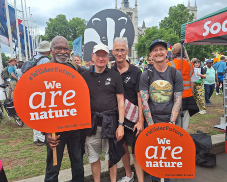 a group of London Wildlife Trust staff with large signs