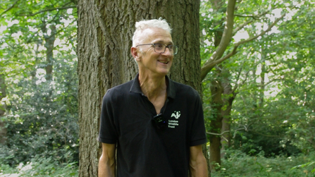 Mathew Frith standing in front of a tree in the woodland of Bramley Bank