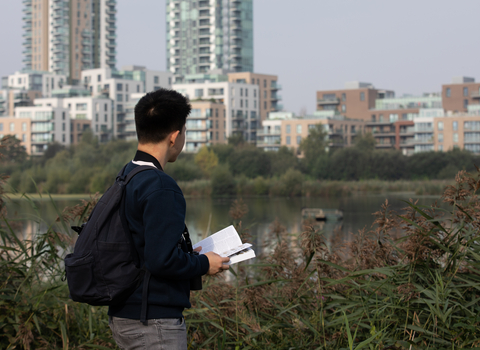 Young person with book at Woodberry Wetlands