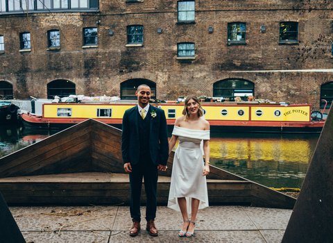 A couple stand in front of the river in Camley