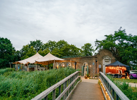 a building with a gazebo at Woodberry wetlands decorated with festoon lights