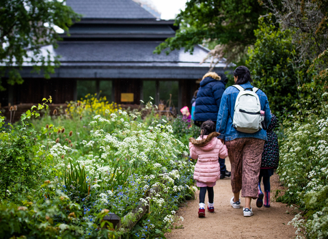 School children and adults walking along the path at Camley Street Natural Park