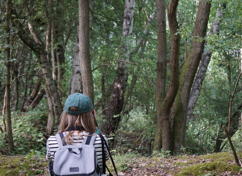 Woman taking a photograph in Dews Farm Sandpits