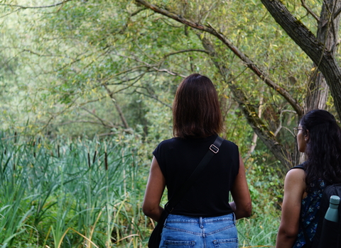 Two women looking out at greenery at Park Road Pond